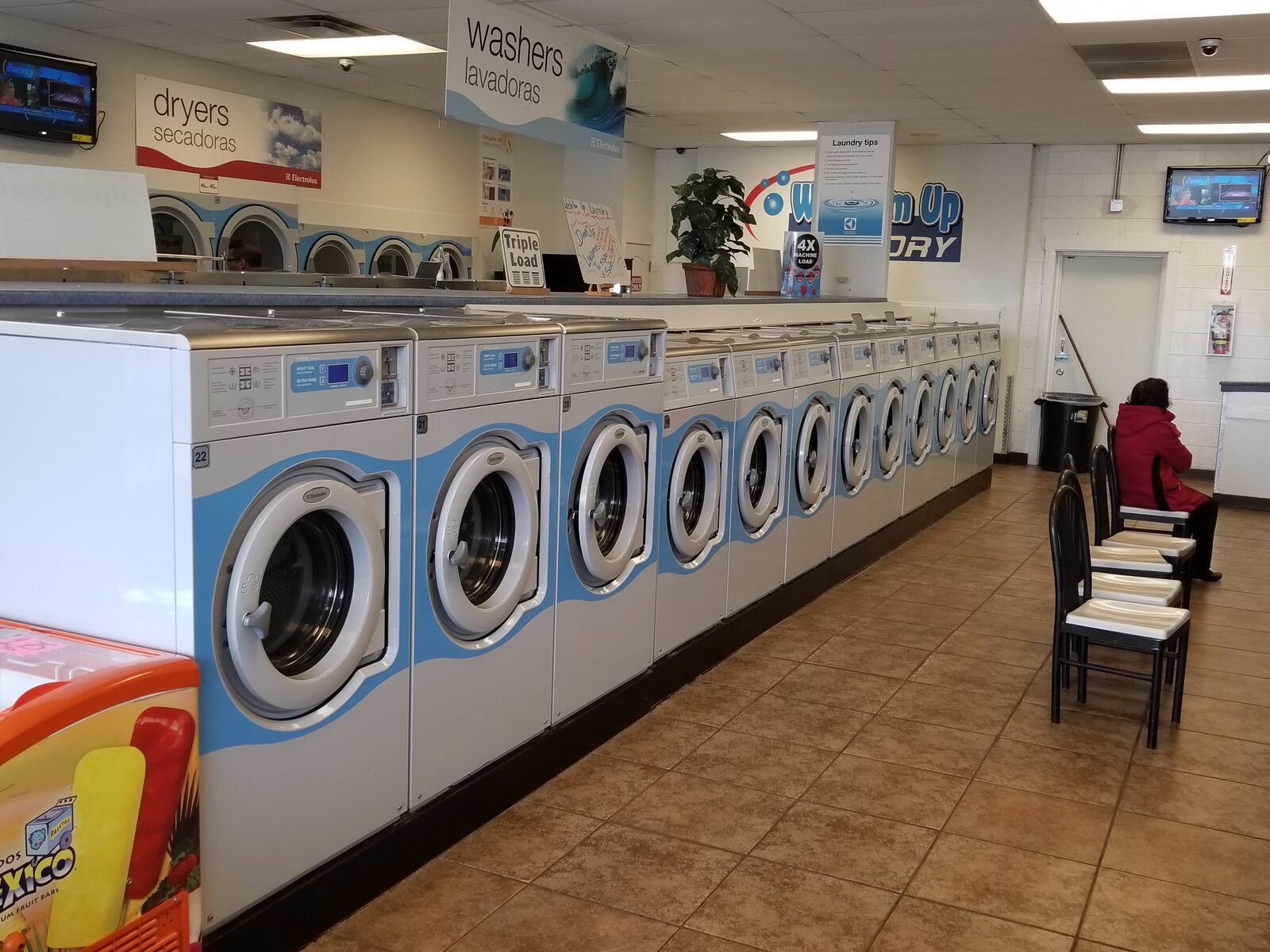 Rows of laundry machines inside Wash'em Up Laundry #1 - Laundromat Denver