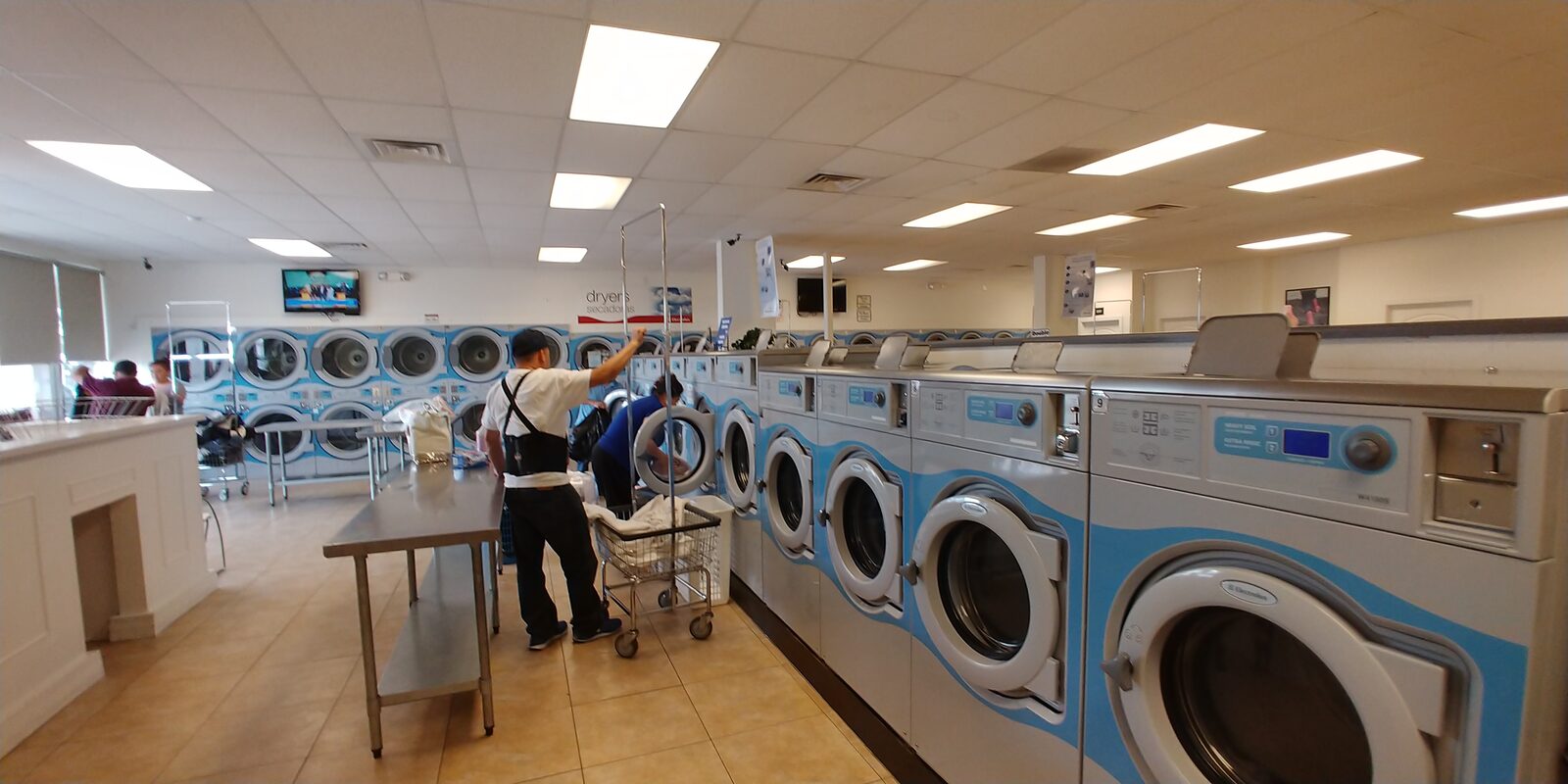 Rows of laundry machines inside Wash'em Up Laundry #5 - Laundromat Thornton